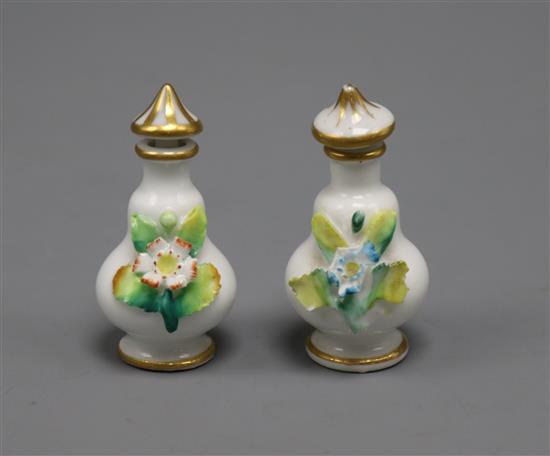 A pair of miniature floral encrusted scent bottles and stoppers height 6cm